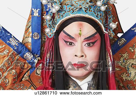 Stock Image - Portrait of a male Chinese opera performer looking serious. Fotosearch