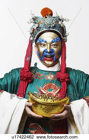 Portrait of a male Chinese opera performer holding a bowl full of gold coins View Large Photo Image Stock Image - Portrait of a male Chinese opera performer holding a bowl full of gold coins. Fotosearch