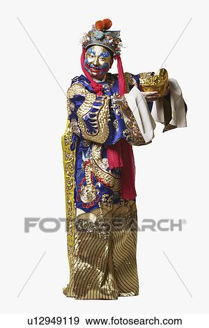 Stock Photo - Portrait of a male Chinese opera performer holding a bowl full of gold coins. Fotosearch