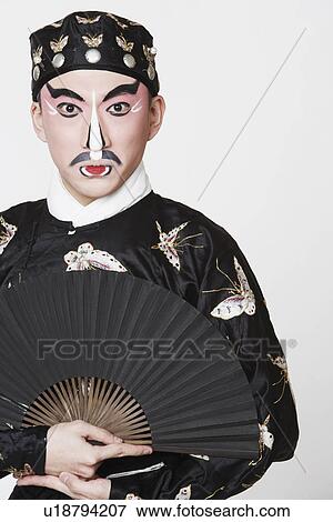 Portrait of a male Chinese opera performer holding a fan View Large Photo Image Stock Photo - Portrait of a male Chinese opera performer holding a fan. Fotosearch