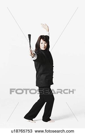Stock Image - Portrait of a young woman practicing martial arts. Fotosearch