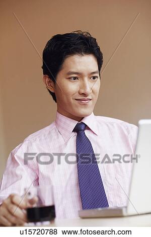 Close-up of a businessman looking at a laptop View Large Photo Image Stock Photo - Close-up of a businessman looking at a laptop. Fotosearch