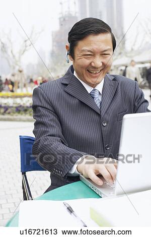 Stock Image - Close-up of a businessman using a laptop. Fotosearch