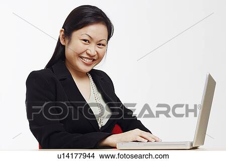 Picture - Portrait of a businesswoman using a laptop. Fotosearch