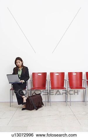 Portrait of a businesswoman using a laptop View Large Photo Image Stock Photograph - Portrait of a businesswoman using a laptop. Fotosearch