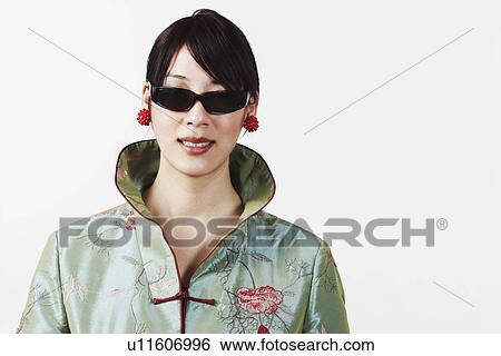 Close-up of a young woman wearing sunglasses View Large Photo Image Stock Photograph - Close-up of a young woman wearing sunglasses. Fotosearch