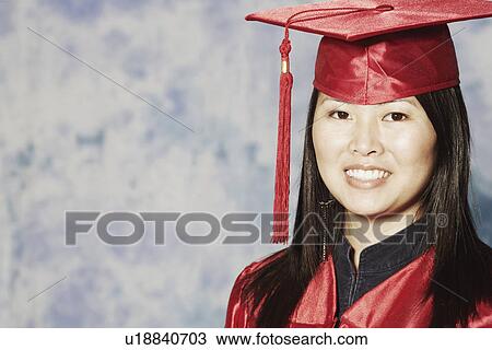 Stock Image - Portrait of a female graduate smiling. Fotosearch