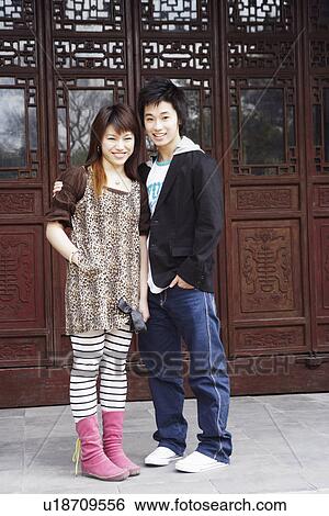 Portrait of a teenage boy standing with a young woman View Large Photo Image Stock Photograph - Portrait of a teenage boy standing with a young woman. Fotosearch