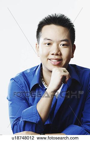 Stock Image - Portrait of a young man smiling. Fotosearch