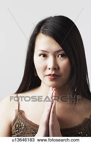 Portrait of a young woman in a prayer position View Large Photo Image Stock Image - Portrait of a young woman in a prayer position. Fotosearch