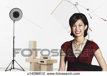 Stock Image - Portrait of a young woman smiling. Fotosearch