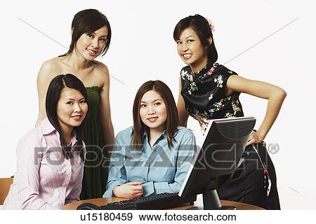 Stock Photo - Portrait of four businesswomen smiling. Fotosearch