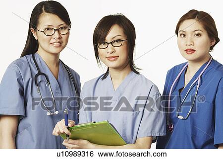 Stock Photograph - Portrait of three female doctors standing together. Fotosearch