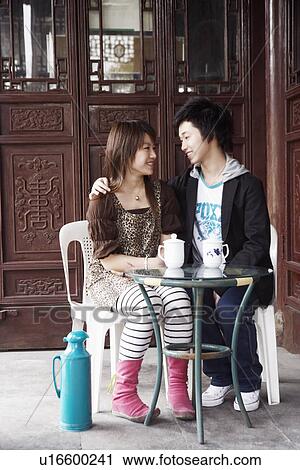 Teenage boy sitting together with a young woman in a restaurant smiling View Large Photo Image Stock Image - Teenage boy sitting together with a young woman in a restaurant smiling. Fotosearch