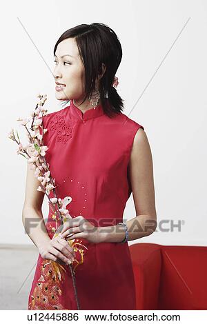 Young woman holding flowers View Large Photo Image Stock Photograph - Young woman holding flowers. Fotosearch