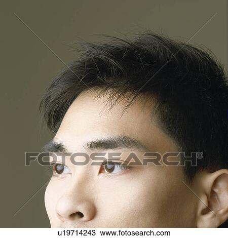 Stock Image - Close-up of a mid adult man thinking. Fotosearch