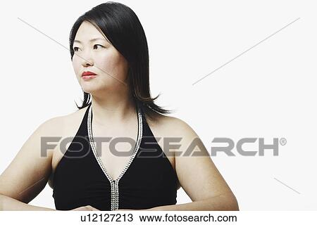 Close-up of a mid adult woman looking sideways View Large Photo Image Stock Image - Close-up of a mid adult woman looking sideways. Fotosearch
