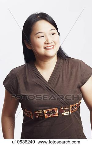 Stock Photo - Close-up of a mid adult woman smiling. Fotosearch