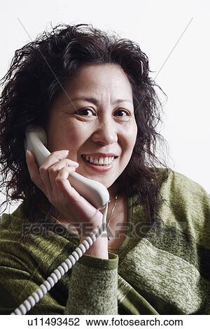Portrait of a businesswoman using a telephone smiling View Large Photo Image Stock Image - Portrait of a businesswoman using a telephone smiling. Fotosearch