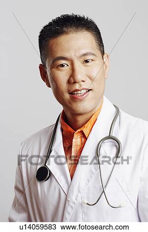 Portrait of a male doctor smiling View Large Photo Image Stock Image - Portrait of a male doctor smiling. Fotosearch