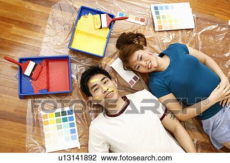 Portrait of a mid adult woman and a young man lying on the floor and smiling View Large Photo Image Stock Image - Portrait of a mid adult woman and a young man lying on the floor and smiling. Fotosearch