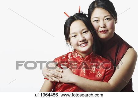 Stock Photograph - Portrait of a mother hugging her daughter. Fotosearch