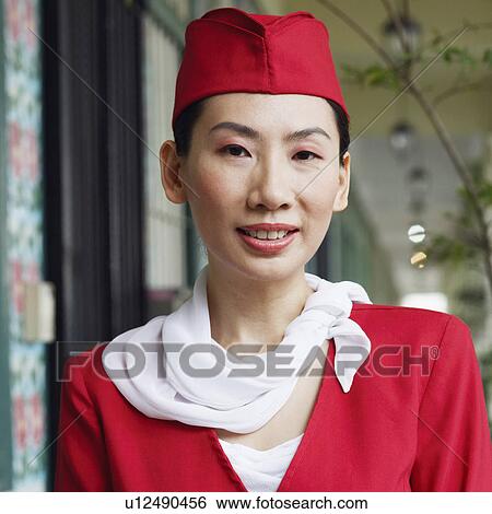 Portrait of an air stewardess smiling View Large Photo Image Stock Photograph - Portrait of an air stewardess smiling. Fotosearch