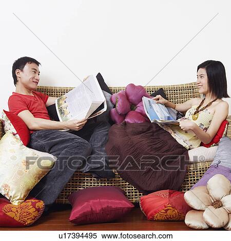 Side profile of a mid adult man with a young woman reclining on a couch and looking at each other View Large Photo Image Stock Photography - Side profile of a mid adult man with a young woman reclining on a couch and looking at each other. Fotosearch