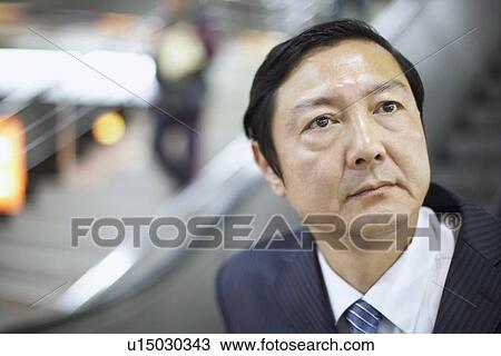 Stock Image - Close-up of a businessman looking up. Fotosearch