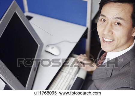 Stock Photography - High angle view of a businessman using a computer. Fotosearch