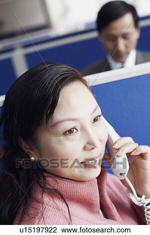 Stock Image - High angle view of a businesswoman talking on the telephone. Fotosearch