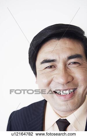 Stock Image - Portrait of a businessman smiling. Fotosearch