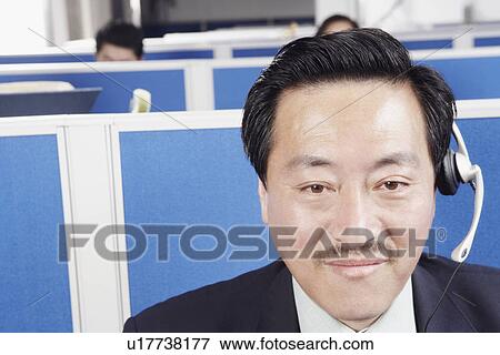 Portrait of a businessman wearing a headset View Large Photo Image Stock Photo - Portrait of a businessman wearing a headset. Fotosearch