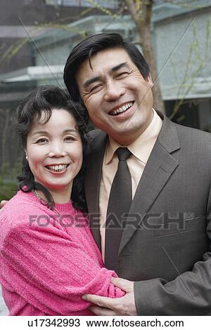 Portrait of a mature couple embracing each other View Large Photo Image Stock Image - Portrait of a mature couple embracing each other. Fotosearch