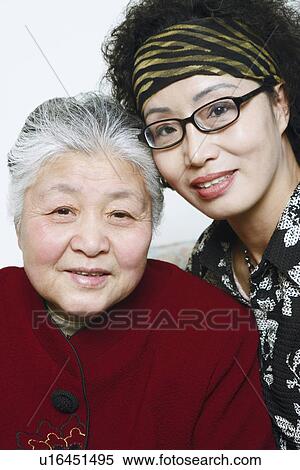 Stock Photography - Portrait of a mature woman and a senior woman posing. Fotosearch