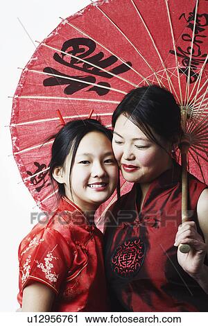 Close-up of a mother and her daughter smiling View Large Photo Image Stock Image - Close-up of a mother and her daughter smiling. Fotosearch