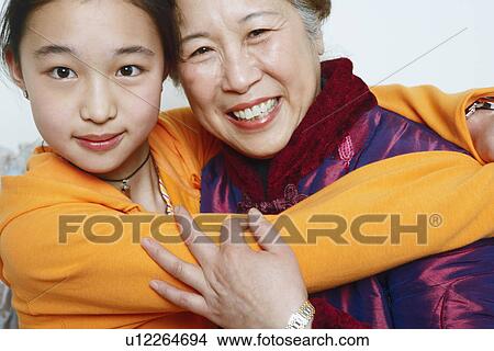Portrait of a daughter hugging her mother View Large Photo Image Picture - Portrait of a daughter hugging her mother. Fotosearch