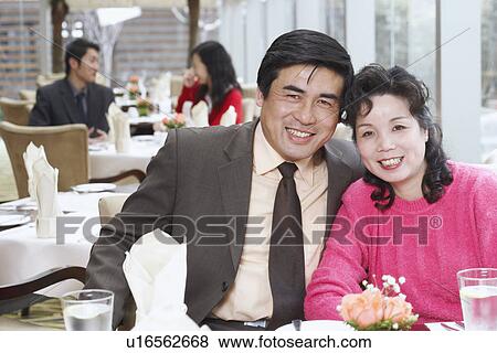 Portrait of a mature couple sitting in a restaurant smiling View Large Photo Image Stock Photo - Portrait of a mature couple sitting in a restaurant smiling. Fotosearch