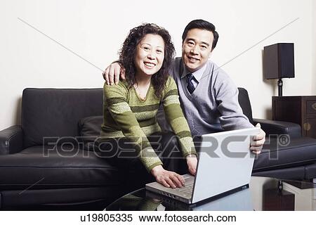 Portrait of a mature couple using a laptop smiling View Large Photo Image Stock Photography - Portrait of a mature couple using a laptop smiling. Fotosearch