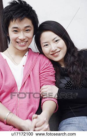 Portrait of a teenage boy smiling with a young woman View Large Photo Image Stock Image - Portrait of a teenage boy smiling with a young woman. Fotosearch