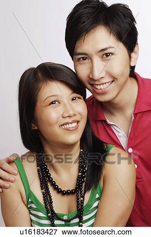 Portrait of a young couple smiling View Large Photo Image Stock Photo - Portrait of a young couple smiling. Fotosearch