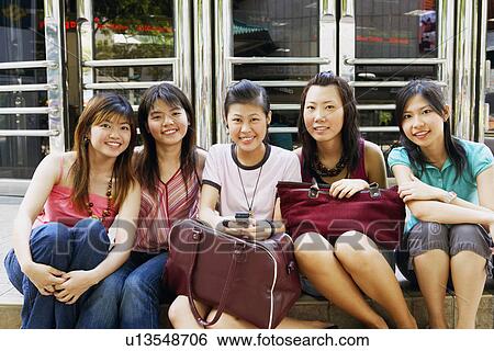 Portrait of five young women sitting together and smiling View Large Photo Image Stock Photograph - Portrait of five young women sitting together and smiling. Fotosearch