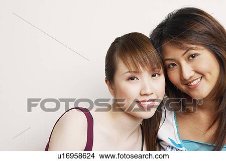Portrait of two young women smiling View Large Photo Image Picture - Portrait of two young women smiling. Fotosearch