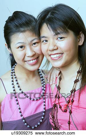 Portrait of two young women smiling View Large Photo Image Stock Photography - Portrait of two young women smiling. Fotosearch