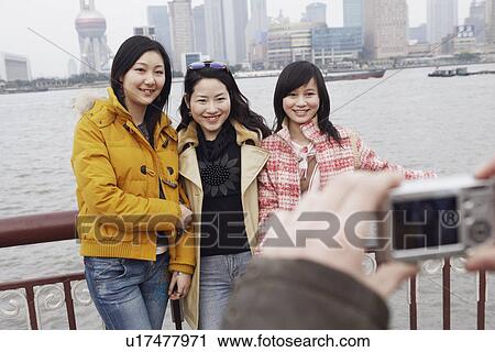 Three young women posing View Large Photo Image Stock Image - Three young women posing. Fotosearch