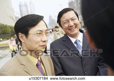 Close-up of two businessmen smiling View Large Photo Image Picture - Close-up of two businessmen smiling. Fotosearch
