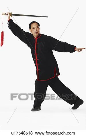 Stock Photo - Mature man holding a sword. Fotosearch