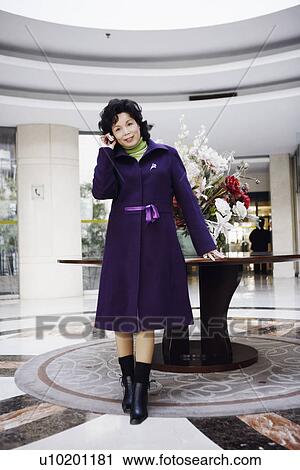 Portrait of a businesswoman talking on a mobile phone smiling View Large Photo Image Stock Image - Portrait of a businesswoman talking on a mobile phone smiling. Fotosearch
