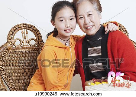 Portrait of a granddaughter with her arm around her grandmother View Large Photo Image Stock Photograph - Portrait of a granddaughter with her arm around her grandmother. Fotosearch