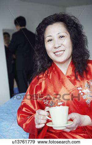 Portrait of a mature woman holding a cup of a tea smiling View Large Photo Image Stock Photo - Portrait of a mature woman holding a cup of a tea smiling. Fotosearch